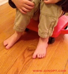 kid on plastic scooter