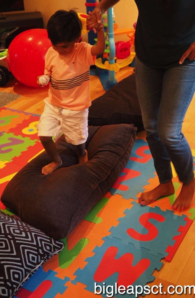 kid stepping on pillows